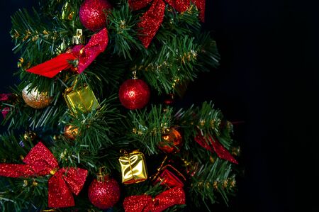 Beautiful Christmas tree with red decorations on a dark backgroundの写真素材