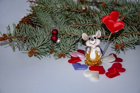 Christmas rat on a background of Christmas branches and hearts. Valentine's Dayの写真素材