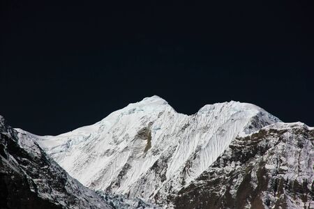 Snowy mountains of Nepal and dark skyの写真素材