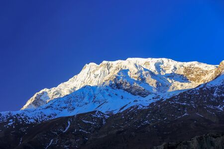 Snowy mountains of Nepal on a background of blue sky.の写真素材