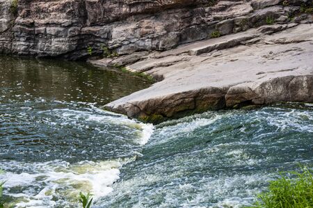 A mountain river flows in a canyon. Summer concept.の写真素材