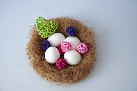 Easter eggs in a nest on a blue background. Copy space for textの写真素材