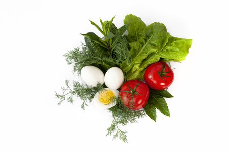 Vegetables on a plate. Tomatoes, lettuce, cucumbers, dill, eggs on a white background. Ingredients for the salad. Healthy nutrition, vitamins.の写真素材