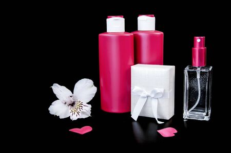 Cosmetic products - cream, tonic and body care, face and hair on a black background. Present.の写真素材