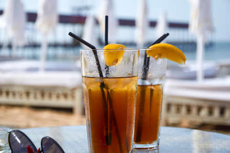 Cocktails on the beach. Bright cold drinks on the beach in summer. Summer vacation and travel concept.の写真素材