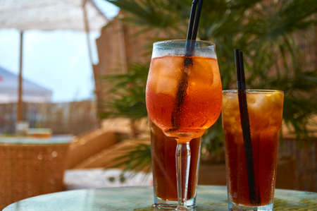 Cocktails on the beach. Bright cold drinks on the beach in summer. Summer vacation and travel concept.の写真素材