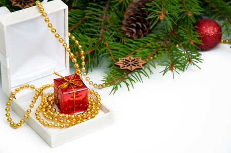 Branches of a Christmas tree and red and yellow gift boxes and balls on a white background. Christmas background with copyspaceの写真素材