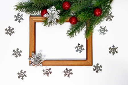 Christmas decorations. Wooden frame and fir branches with decorations on white backgroundの写真素材