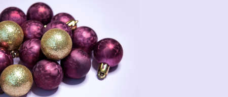 Purple and gold christmas balls on a light backgroundの写真素材