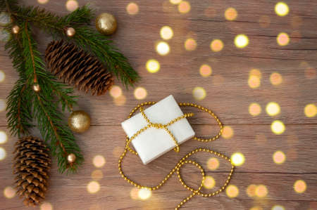 Christmas branches, pine cones, golden balls and a gift box. Christmas decorの写真素材