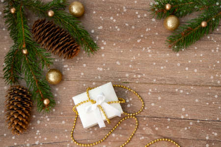 Christmas branches, pine cones, golden balls and a gift box. Christmas decorの写真素材