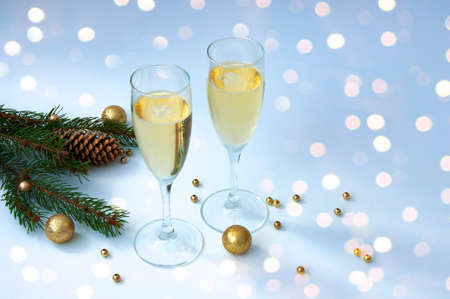 Christmas branches and cones, two glasses of champagne. Christmas decorの写真素材