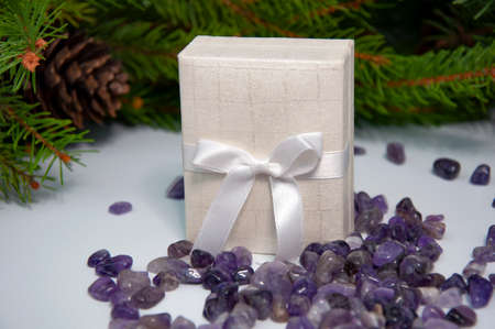 Decorated branches of a Christmas tree, pine cones, a gift box and lilac semi-precious stones amethyst Christmas decor.の写真素材