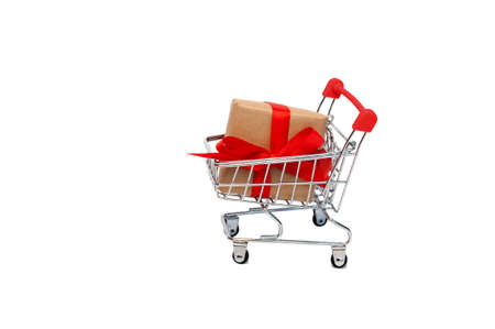 Holiday gifts in a grocery cart on a white background. Buying gifts for the holiday.の写真素材