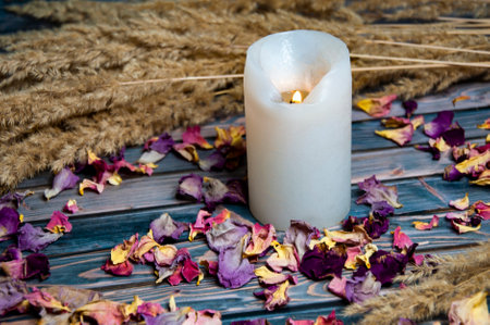 White candle dry flowers on wooden backgroundの写真素材