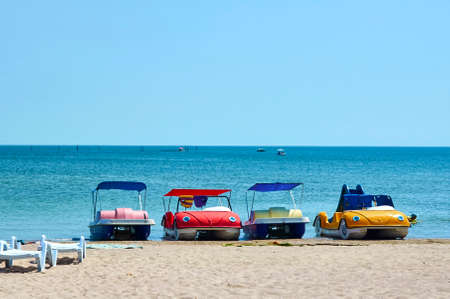 Boats in the form of cars on the beach. Summer rest