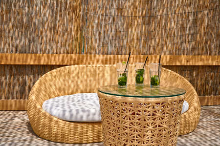 Summer vacation on the beach. Wicker sofa and table with drinks and cocktailsの写真素材
