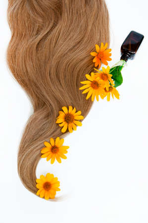 Cosmetic for hair and flowers for hair on a white background. Healthy and beautiful hair. Hair care. Copy space for textの写真素材