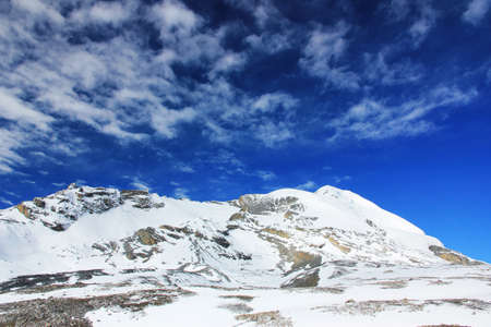 Snowy mountains against the blue sky with white clouds. Mountains of Nepal.の写真素材
