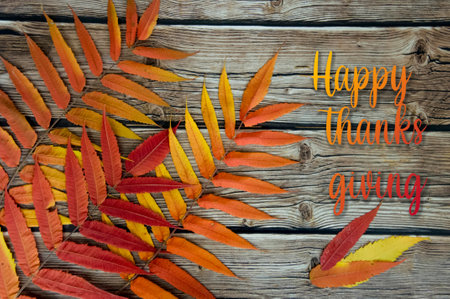 Sumac leaves on a wooden background. Autumn Thanksgiving Day. inscription Happy thanks giving