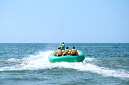 Walk on an inflatable mattress at ocean on a tow of a water motorcycle. Tourists enjoy the ride banana boat.の写真素材