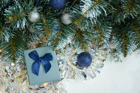 Christmas composition with Christmas tree branches in blue and silver balls and blue gift boxの写真素材