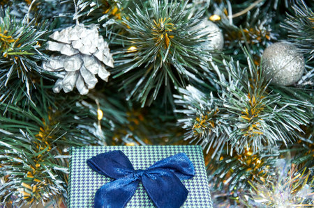 Christmas composition with Christmas tree branches in blue and silver balls and blue gift boxの写真素材