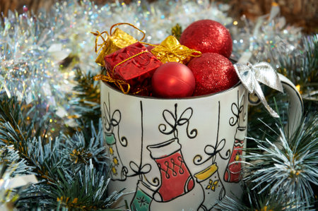 Christmas background with beautiful mug with gifts and balls in beautiful tinselの写真素材