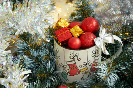 Christmas background with beautiful mug with gifts and balls in beautiful tinselの写真素材
