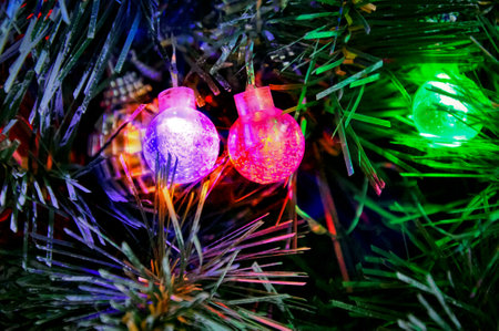 Multicolored glowing Christmas balls garlands close-upの写真素材