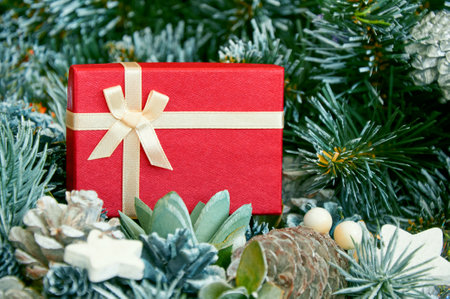 Christmas composition with Christmas tree branches, red tinsel, gift boxes and silver tinsel