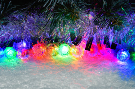 Multicolored glowing Christmas balls garlands close-up