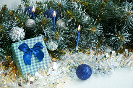 Christmas composition with Christmas tree branches in blue and silver balls and blue gift boxの写真素材