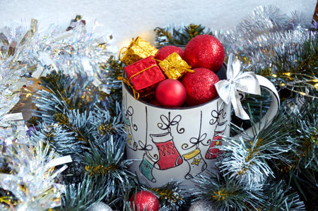 Christmas background with beautiful mug with gifts and balls in beautiful tinselの写真素材