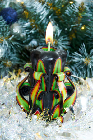 Christmas background with beautiful green candle, green Christmas tree branches and silver tinselの写真素材