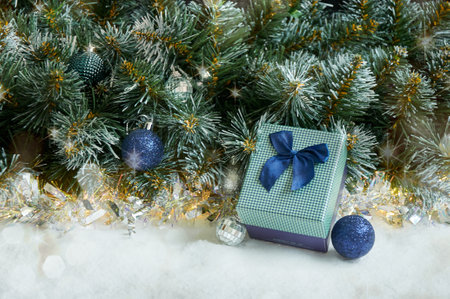 Christmas composition with Christmas tree branches in blue and silver balls and blue gift boxの写真素材
