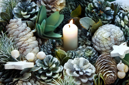 Christmas wreath made of cones and Christmas tree branches on a wooden background. Christmas backgroundの写真素材