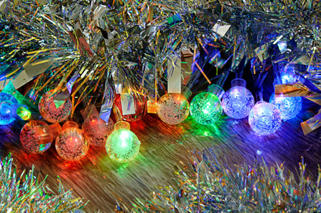 Multicolored glowing Christmas balls garlands close-upの写真素材