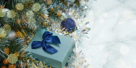 Christmas composition with Christmas tree branches in blue and silver balls and blue gift boxの写真素材