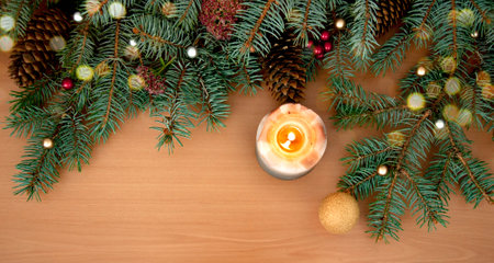 Christmas background. Christmas tree branches, gift, hearts, balls, candles and stars on wooden textureの写真素材