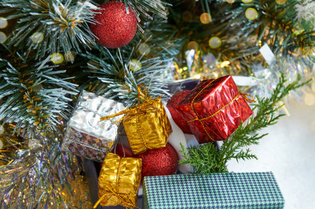 Christmas composition with Christmas tree branches, red tinsel, gift boxes and silver tinselの写真素材