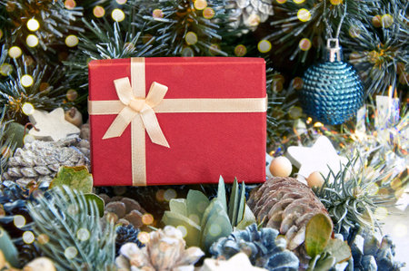 Christmas composition with Christmas tree branches, red tinsel, gift boxes and silver tinselの写真素材