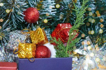 Christmas composition with Christmas tree branches, red tinsel, gift boxes and silver tinselの写真素材
