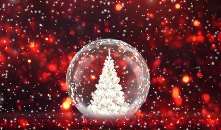 Christmas tree in a snow globe on a red background with snowflakesの写真素材