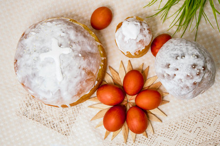 Easter cakes and red eggs on a linen cloth, selective focus, top viewの写真素材