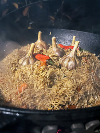 Close-Up of Aromatic Pilaf with Garlic and Chili Peppers â Rustic Rice Dish in Black Panの写真素材