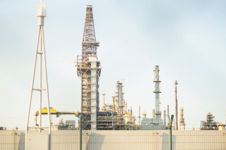 constructions, buildings, towers, chimneys, pipelines at a petrochemical plant in focus and out of focus, in selective focus. Industrial view of the factory areaの写真素材