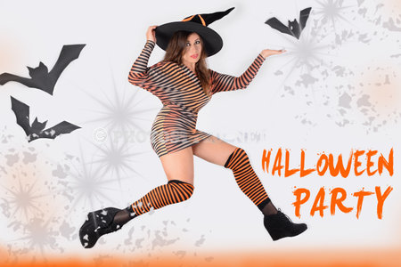 Pretty woman in halloween style costume and witch sorceress hat laughing, posing on white background with black bats.の写真素材