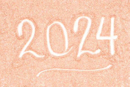 Festive background of blurred glitter of Christmas holiday sparkles in peach hue, color of the year...