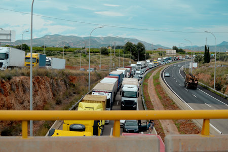 Long traffic jam of trucks and cars on a highway, pollution, CO2 emissions, truckingの写真素材